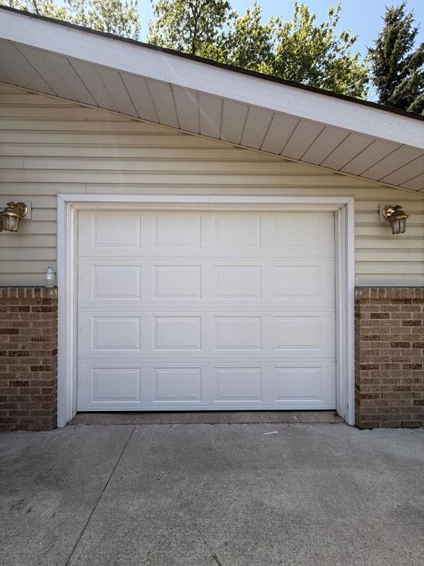 White raised-panel single garage door
