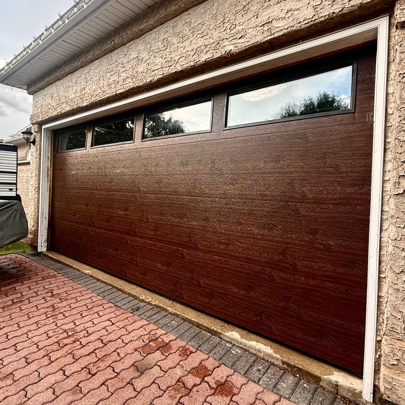 Dark wood-grain garage door with top windows