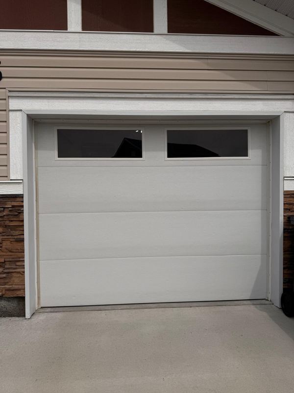 Light grey garage door with top windows