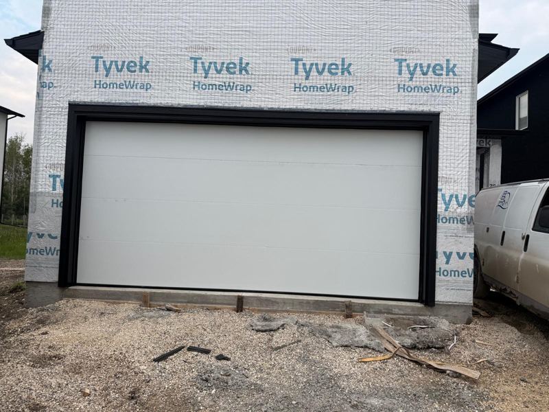White flush garage door on new construction